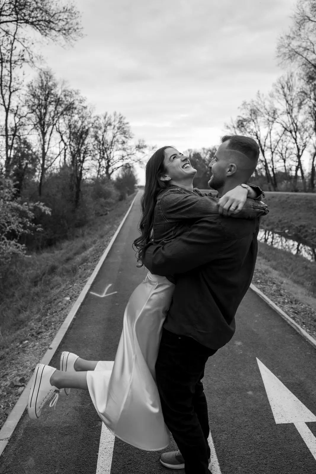 Muž dvíha partnerku, čiernobiela fotografia